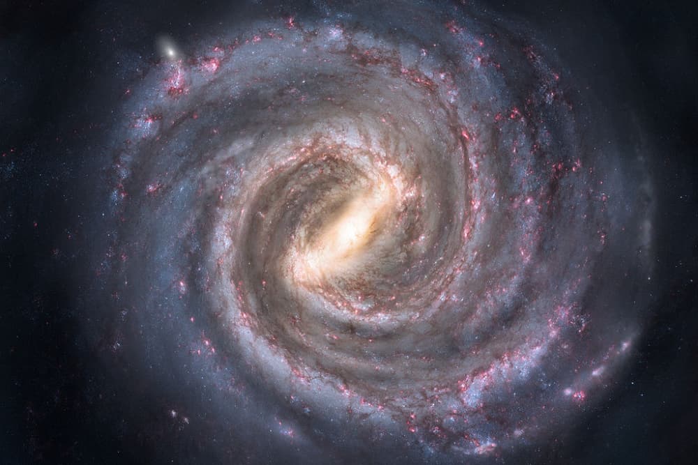 A swirling spiral galaxy illuminated by stars and cosmic dust.